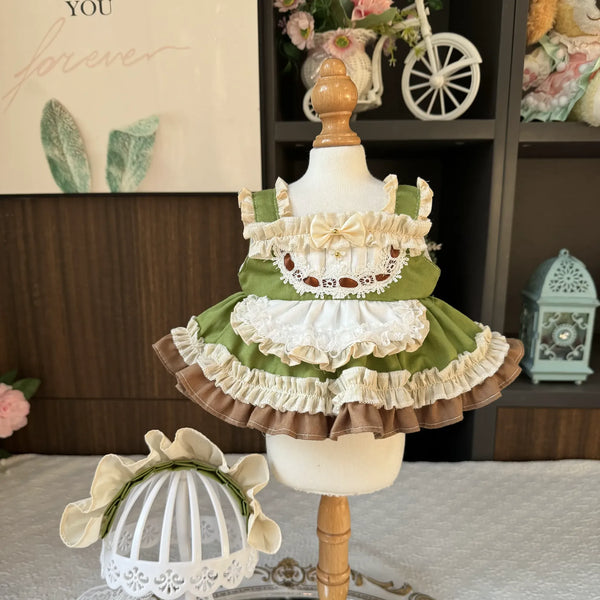 Matcha Latte Apron Dress & Bonnet for cotton dolls: green dress, white lace apron, cream bow, cream bonnet, front view