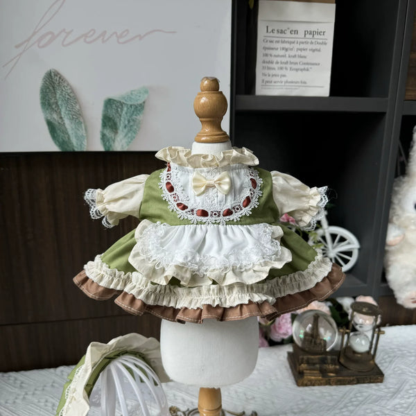 Meadow Picnic Apron Dress & Bonnet for cotton dolls: green dress, cream sleeves, white lace apron, embroidered bib, bonnet, front view