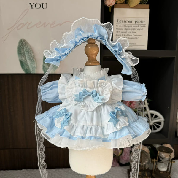 Sky Ribbon Apron Dress & Ruffle Headband for cotton dolls: light blue dress, white ruffled apron, blue bows, ruffled headband, front view