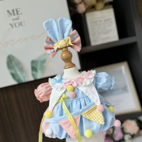 Circus Bunny Dress & Bunny Ear Bow for cotton dolls: light blue dress, pink and blue sleeves, pastel pompoms, bunny ear bow, front view
