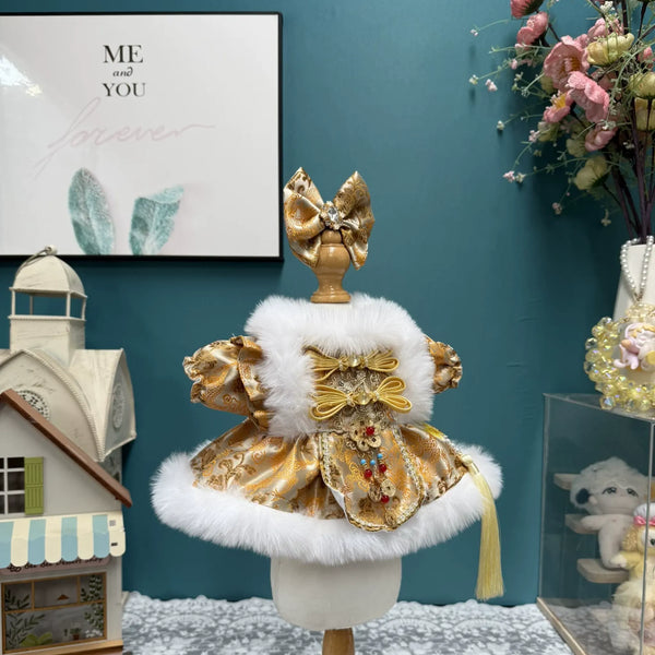 Golden Winter Dress & Hair Bow for cotton dolls: gold pattern, fluffy white trim, gold bow fastenings, tassel, front view
