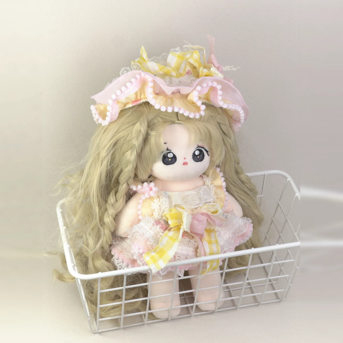 Cotton doll wearing the Lemon Sherbet outfit: pink lolita dress with yellow gingham bows and a frilled pink bonnet, front view