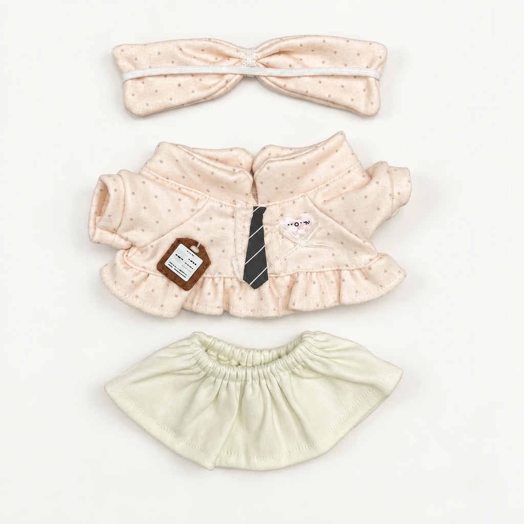 Little Whispers three-piece doll outfit laid flat: blush polka-dot bow headband, blouse with striped tie and pale green skirt.