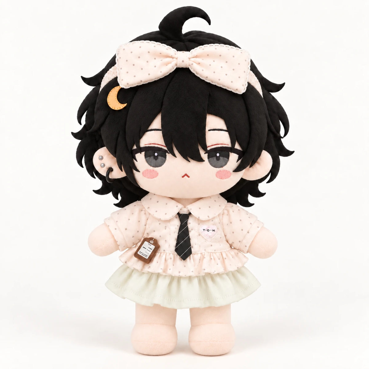 Black-haired cotton doll wearing the Little Whispers outfit: blush polka-dot bow and blouse, striped tie and pale green skirt.