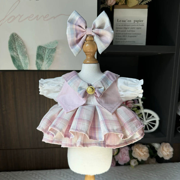 Pastel Campus Plaid School Dress & Bow for cotton dolls: pink-lilac plaid pleated skirt, white puff sleeves, plaid hair bow, front view
