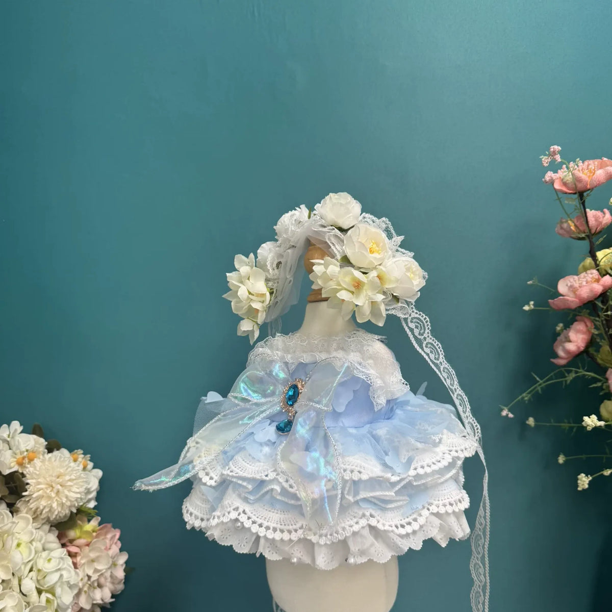 Powder Blue Garland Lace Dress & Flower Crown for cotton dolls: light blue dress, lace tiers, gem brooch, flower crown, front view