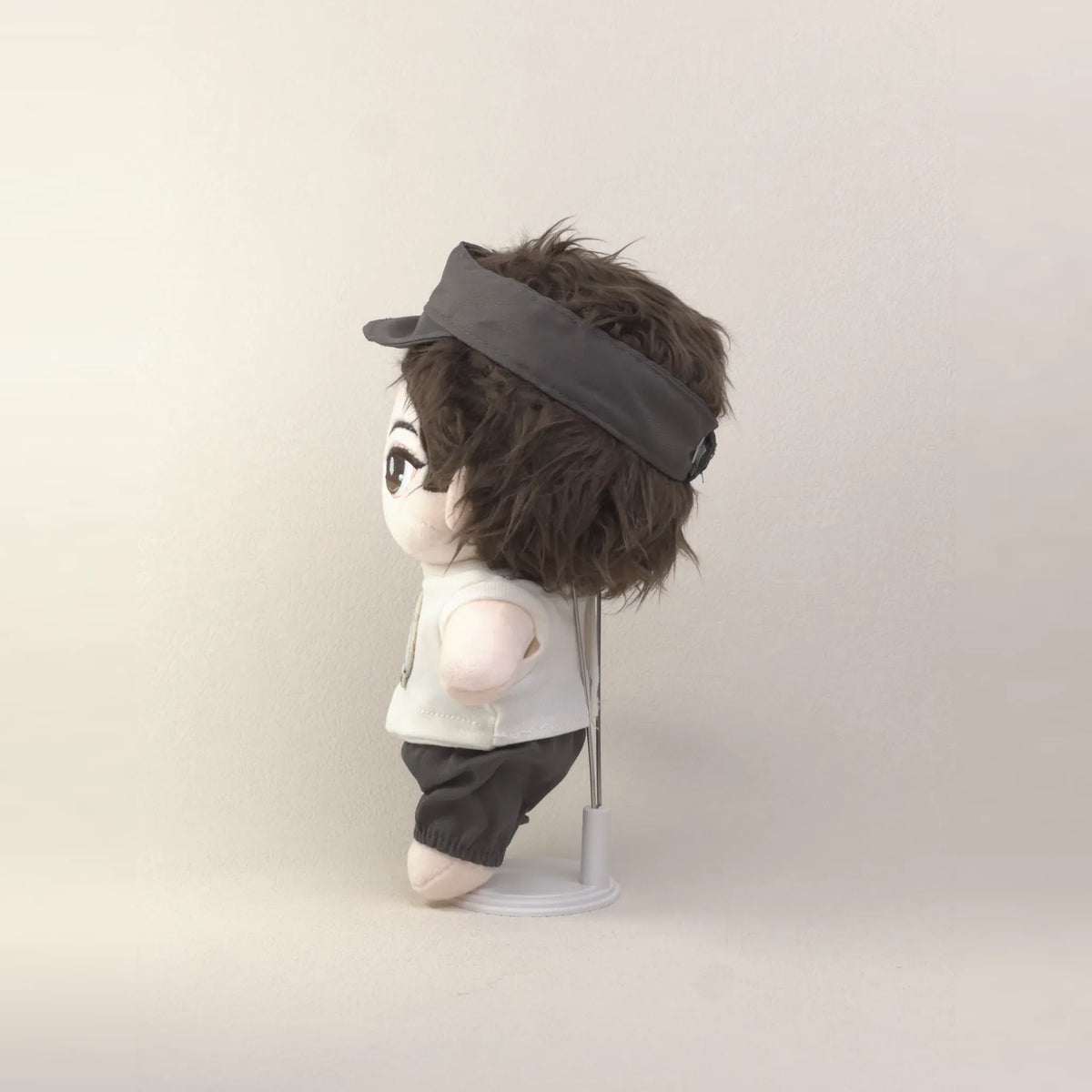 Cotton doll wearing the Puppy Pal outfit: white puppy-patch T-shirt, charcoal shorts and charcoal cap, side view