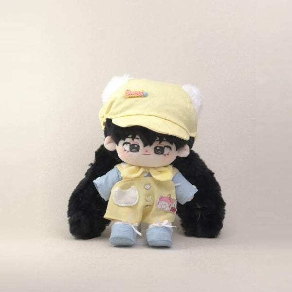 Cotton doll wearing the Sunny Kitten outfit: yellow overalls, light blue shirt, yellow neck bow, cat-ear cap and blue shoes, front view